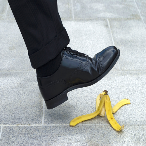 Businessman-stepping-on-banana-skin
